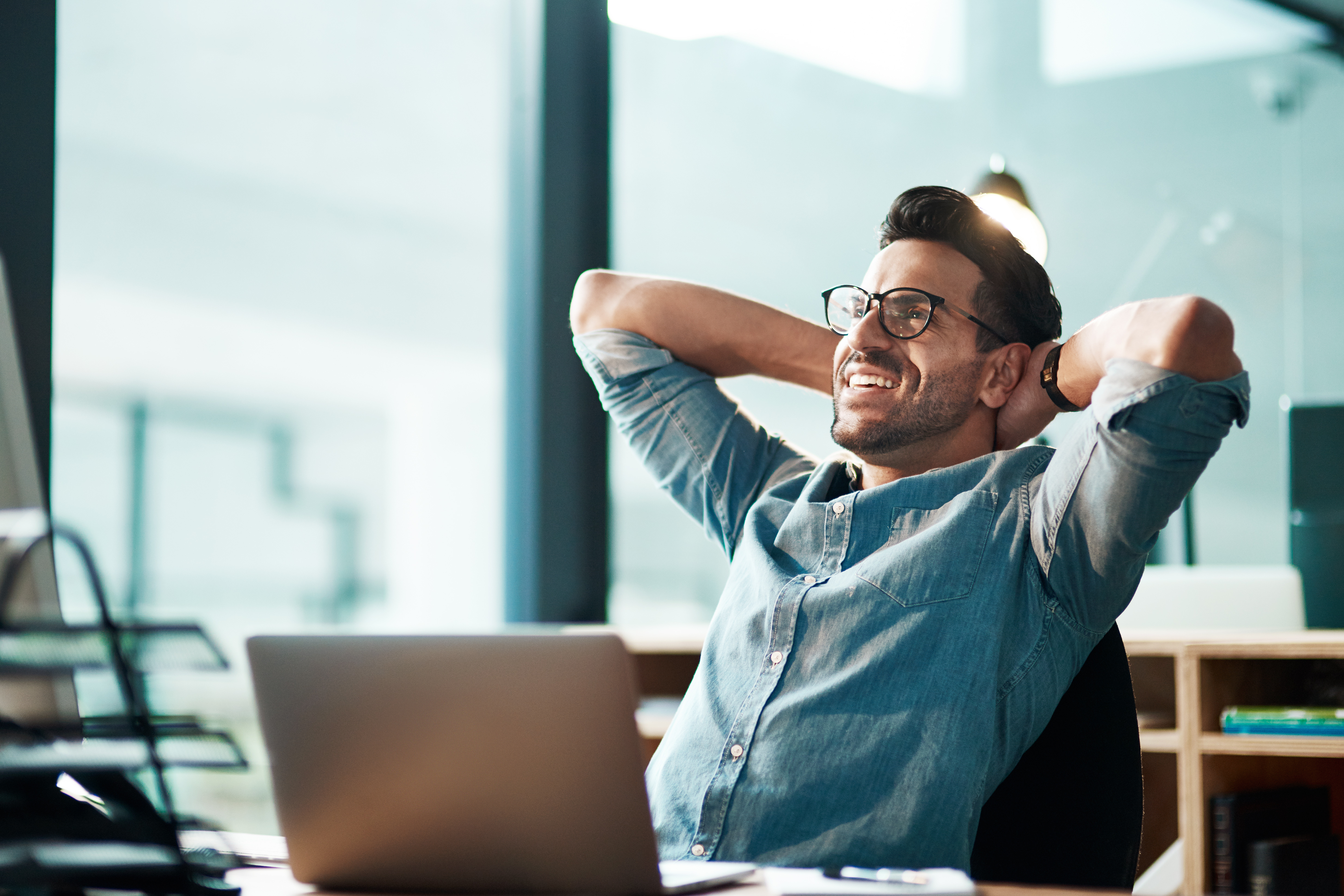 Man zit relaxt aan zijn laptop