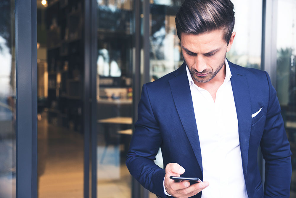 man in pak met smartphone in de hand