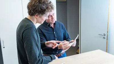 man talking to another man about a document